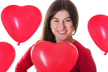 Fototapeta na wymiar Woman holding red heart shaped balloon
