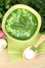 Tasty spinach soup, on wooden table