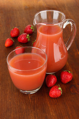 Delicious strawberry juice on table close-up