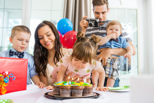 Family Celebrating Girl's Birthday At Home
