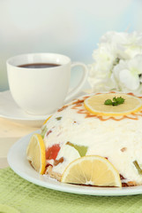 Delicious jelly cake on table on light background