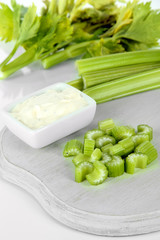 Fresh green celery on cutting board close-up