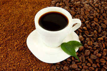 Cup of coffee on coffee background