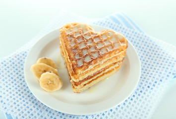 Sweet Belgium waffles with banana, isolated on white