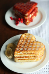 Sweet waffles on  plates. on wooden background