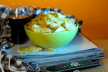 Chips in bowl, cola and TV remote