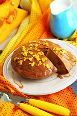 Delicious pumpkin pie on plate on wooden table close-up