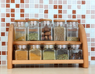 Set of spices in kitchen on table on mosaic tiles background