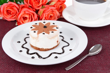 Sweet cake with chocolate on plate on table close-up