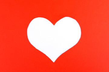 Paper heart on red background