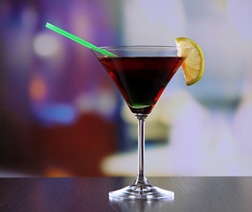 Glass of tasty cocktail on bright background