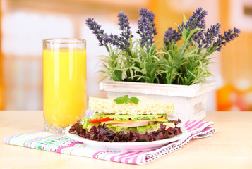 Fresh and tasty sandwich on plate on table on light background