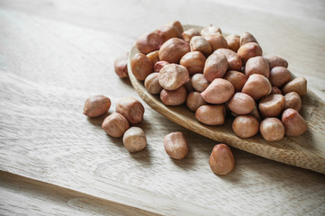 Peanuts closeup on wood ladle