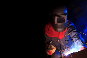 Working welder on black background with copy space