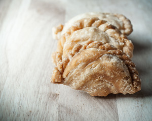Snack of curry puffs on wooden