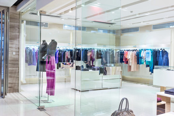 Boutique display window with mannequins in fashionable dresses