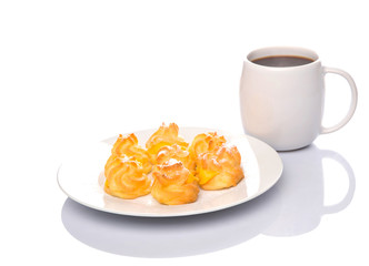 Homemade cream puff and a mug of coffee