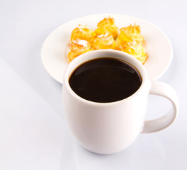 Homemade cream puff and a mug of coffee