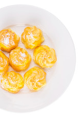 Homemade cream puff over white background