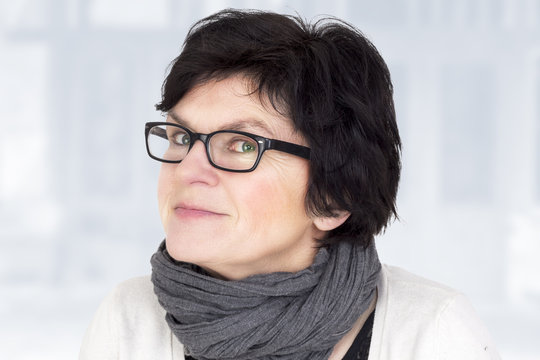 Portrait of a woman with glasses in middle age