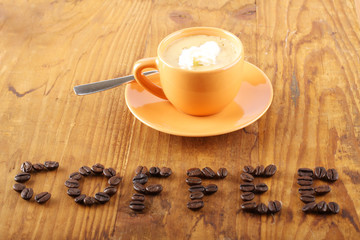 Cup of coffee with coffee beans