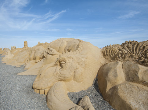 Large Sand Sculpture Of A Dinosaur