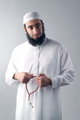 Arabian religious muslim man holding rosemary - obrazy, fototapety, plakaty