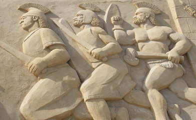 Sand sculpture of roman warriors in battle