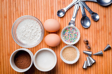 Fototapeta na wymiar Basic cake and muffin ingredients on wooden background