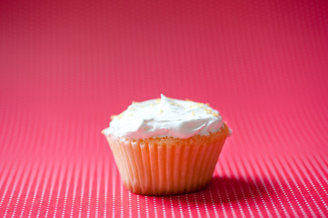 Vanilla cupcake with cream topping and crunchy cookies on top is