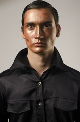 Obraz premium Sexy man wearing make up, dressed in a black shirt