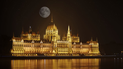 Fototapeta na wymiar Parliament of Budapest, Hungary at night by the full moon