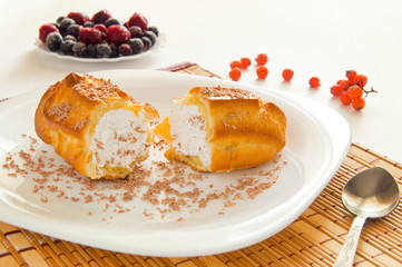 cream cake on a white plate and berry