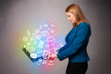 Young lady holding notebook with colorful hand drawn multimedia