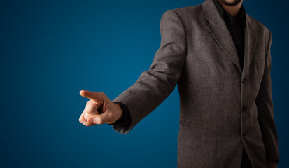 Fototapeta premium Businessman pressing imaginary button
