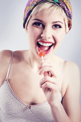 Smiling vintage looking girl with lollipop