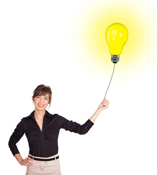 Happy woman holding a light bulb balloon