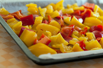 Mix red and yellow peppers cut into pieces and put into the pan.