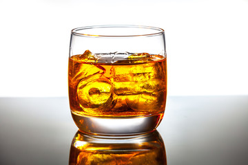 Glass and bottle of hard liquor like scotch, bourbon, whiskey or
