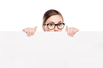 businesswoman looking over top of white sign