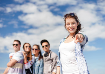 teenage girl with headphones and friends outside