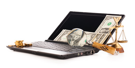 laptop computer keyboard  money and magnifying glass