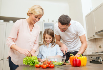 Obraz na płótnie Canvas happy family making dinner in kitchen