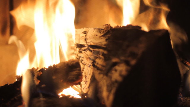 Burning wood in stone fireplace