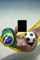 Brazilian Man Relaxing with Tablet and Football Beach Hammock