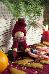 Decorative wooden doll on christmas background. Close-up.