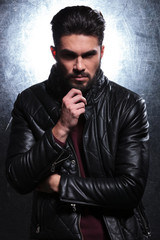 Obraz premium pensive fashion young man in leather jacket