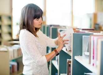 Student Selecting Books In Bookstore