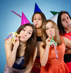 Joyful teen girls have fun on birthday party