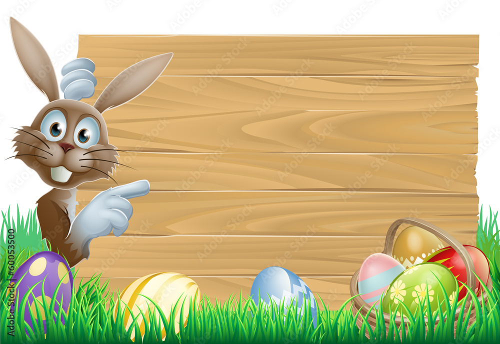 Wall mural easter bunny pointing at sign